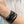 vue taille réelle, portée par mannequin, bracelet safari, couleur noir paillettes. Ladygum, marque française, bijoux fantaisies en silicone. Bracelet ajustable, réglable, souple, léger, minimisant les allergies. Le petit plus chic : la couleur noir avec paillettes. Style tribal, manchette, nature, ajouré, multirang, ethnique, tribal. Idée cadeau original.