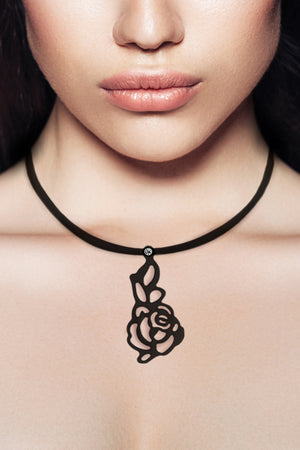 zoom, vue gros plan, collier pendentif rose japonaise long, couleur noir. Vue taille réelle, porté. Silicone, ladygum, bijoux fantaisies, marque française, créateurs, designers. Style simple, minimaliste. Collier simplissimo avec strass couleur cristal, amovible, riveté, avec pendentif boucle rose japonaise long, nature, fleur, amour, romantique. Léger, souple, résistant à l'eau, à la chaleur, à la lumière. Collier ajustable, longueur réglable, fermoir en T. Cadeau original. 