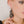 zoom, gros plan, vue boucles d'oreilles rose japonaise modèle long, couleur noir. Portées par mannequin dorine gaudin. Attache dormeuse en acier inoxydable. Silicone, marque française, ladygum, bijoux fantaisies en silicone. Style fleur, floral, nature, romantique, pendantes, longues. Résistante à l'eau/à la chaleur/à la lumière. Souple, léger, original.