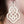 vue gros plan, zoom, paire de boucles d'oreilles arabesque, couleur blanc. Vue portée sur mannequin. LadyGum, bijoux fantaisies en silicone, créateurs, designers. Style celtique, baroque, gothique, tribal, pendante. Attache dormeuse en acier inoxydable, légères, souples, waterproof. Cadeau original.