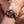 zoom, vue gros plan, bracelet courbe, couleur noir. Vue taille réelle, porté sur poignet par mannequin Dorine Gaudin. Bijoux fantaisies en silicone, ladygum, marque française, créateurs, designers. Style nature, manchette femme, fleur, rond, cercle, tourbillon, abstrait, contemporain. Léger, souple, longueur réglable, bracelet ajustable, fermoir en T, résistant à l'eau, à la chaleur, à la lumière, minimisant les allergies. Cadeau original.