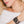 zoom, vue gros plan, bracelet hibiscus, couleur noir. Vue taille réelle, porté sur poignet par mannequin Dorine Gaudin. Bijoux fantaisies en silicone, ladygum, marque française, créateurs, designers. Style manchette femme, nature, fleur, floral, exotique, tropical, île, feuilles, plage. Léger, souple, longueur réglable, bracelet ajustable, fermoir en T, résistant à l'eau, à la chaleur, à la lumière, minimisant les allergies. Cadeau original.