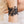 zoom, vue gros plan, bracelet hippie, couleur noir. Vue taille réelle, porté sur poignet par mannequin Dorine Gaudin. Bijoux fantaisies en silicone, ladygum, marque française, créateurs, designers. Style manchette femme, nature, fleur, floral, paquerette, marguerite, année 70. Léger, souple, longueur réglable, bracelet ajustable, fermoir en T, résistant à l'eau, à la chaleur, à la lumière, minimisant les allergies. Cadeau original.