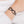 zoom, vue gros plan, bracelet noeud, couleur noir. Vue taille réelle, porté sur poignet par mannequin Dorine Gaudin. Bijoux fantaisies en silicone, ladygum, marque française, créateurs, designers. Style simple, minimaliste, noeud papillon, ruban, manchette femme. Léger, souple, longueur réglable, bracelet ajustable, fermoir en T, résistant à l'eau, à la chaleur, à la lumière, minimisant les allergies. Cadeau original.