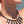 zoom, vue gros plan, collier émeraude, couleur noir. Vue taille réelle, porté par mannequin dorine gaudin. Bijoux fantaisies en silicone, ladygum, marque française, créateurs, designers. Style long, pendant, plongeant, plastron, losange, géométrique, minimaliste, simple, effet pierre/cristaux. Léger, souple, résistant à l'eau/à la chaleur/à la lumière. Collier ajustable, longueur réglable, fermoir en T. Cadeau original.