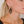 zoom, vue gros plan, paire de boucles d'oreilles diamant, couleur noir. Portées par mannequin Dorine Guadin. Bijoux fantaisies en silicone, marque française, créateurs, designers. Style losange, triangle, géométrique, graphique, moderne, contemporain. Attache dormeuse en acier inoxydable. Minimisant les allergies, résistant à l'eau/à la chaleur/à la lumière, souple, léger. Cadeau original.