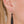 zoom, vue gros plan, paire de boucles d'oreilles emeraude, couleur noir. Portées par mannequin Dorine Gaudin. Bijoux fantaisies en silicone, marque française, créateurs, designers. Style pendante, minimaliste, feuille, longues. Attache dormeuse en acier inoxydable. Minimisant les allergies, résistant à l'eau/à la chaleur/à la lumière, souple, léger. Cadeau original.
