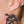 zoom, vue gros plan, paire de boucles d'oreilles hibiscus, couleur noir. Portées par mannequin Dorine Gaudin. Bijoux fantaisies en silicone, marque française, créateurs, designers. Style tropical, fleur, floral, nature, île, exotique, jungle, plage, mer. Attache dormeuse en acier inoxydable. Minimisant les allergies, résistant à l'eau/à la chaleur/à la lumière, souple, léger. Cadeau original.